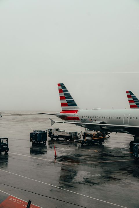 Passenger airplane on a wet tarmac on a foggy day